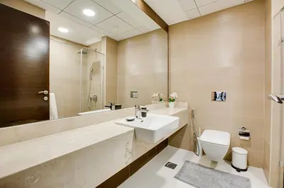 a bathroom with a sink and a toilet at 1BD apt in Sparkle Tower by Swarovsky big capacity in Dubai