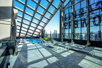a view of a building with a pool and chairs at 1BD apt in Sparkle Tower by Swarovsky big capacity in Dubai