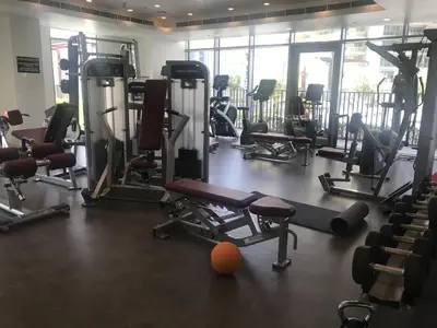 a gym with a bunch of treadmills and machines at Elegant Apt With Balcony Minutes from Burj Khalifa in Dubai
