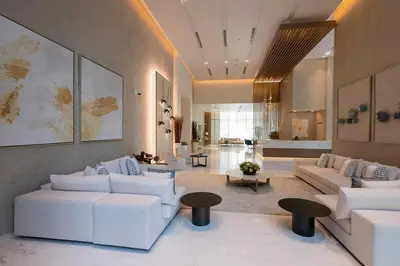 a large living room with white couches and tables at Elegant Apt With Balcony Minutes from Burj Khalifa in Dubai