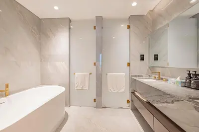 a white bathroom with two sinks and a tub at FIVE Palm Residence - Platinium Dubai in Dubai