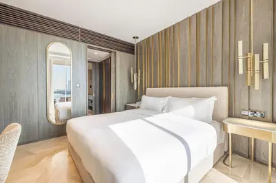 a bedroom with a large white bed and a desk at FIVE Palm Residence - Platinium Dubai in Dubai