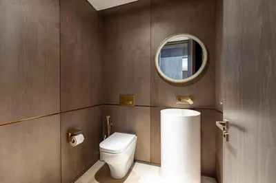 a bathroom with a toilet and a mirror at FIVE Palm Residence - Platinium Dubai in Dubai