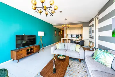 a living room with a couch and a tv at Index Tower by Radiance Vacation Stays 43rd Floor in Dubai