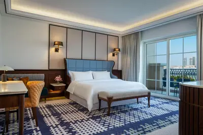 a bedroom with a bed and a desk and a window at The Westin Dubai Mina Seyahi Beach Resort and Waterpark in Dubai