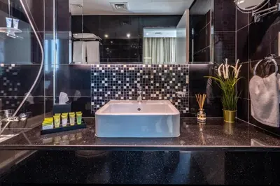 a bathroom with a sink and a mirror at The Smart Concierge - The Vogue in Dubai