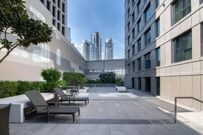 a courtyard of a building with chairs and tables at The Smart Concierge - The Vogue in Dubai