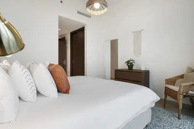 a bedroom with a white bed with pillows at Breathtaking City Views From DT Apt with Terrace in Dubai