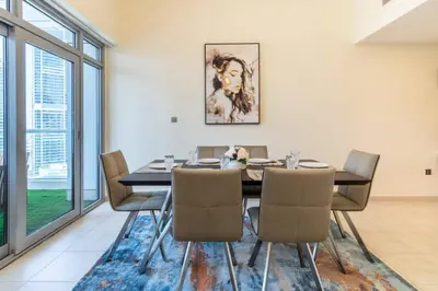 a dining room with a table and chairs at Scenic 2 Bedroom Apartment - Downtown Business Bay in Dubai
