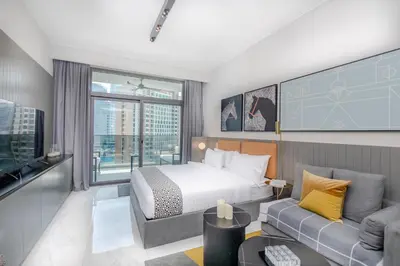 a hotel room with a bed and a couch at Bespoke Holiday Homes - Mag 318 Downtown Dubai in Dubai