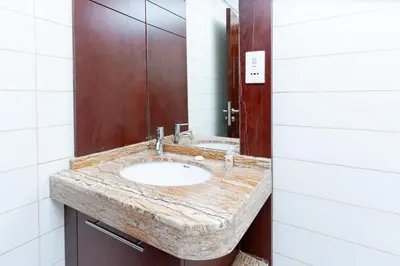 a bathroom with a sink and a mirror at Holidays R Us canal view in Dubai