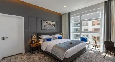 a bedroom with a large bed and a large window at Rose Executive Hotel - DWTC in Dubai