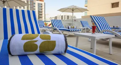 a pillow sitting on a chair on a patio at Rose Executive Hotel - DWTC in Dubai
