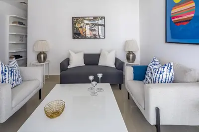 a living room with two couches and a table at Frank Porter - The Medalist in Dubai