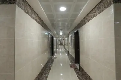 a hallway of a building with tile walls and ceilings at Comfortable Apartments and Studios for Rent in Dubai in Dubai