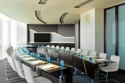a conference room with a long table and chairs at Jumeirah Emirates Towers Dubai in Dubai