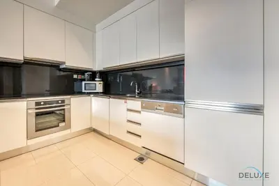 a kitchen with white cabinets and stainless steel appliances at Exquisite 1BR at The Address Residences Dubai Marina by Deluxe Holiday Homes in Dubai