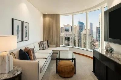 a living room with a couch and a large window at Grosvenor House, a Luxury Collection Hotel, Dubai in Dubai
