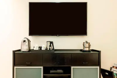 a flat screen tv on a wall above a dresser at Grosvenor House, a Luxury Collection Hotel, Dubai in Dubai