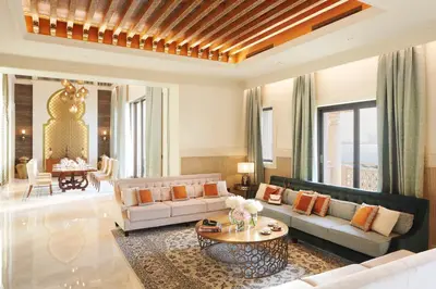 a living room with a couch and a table at Jumeirah Al Qasr Dubai in Dubai