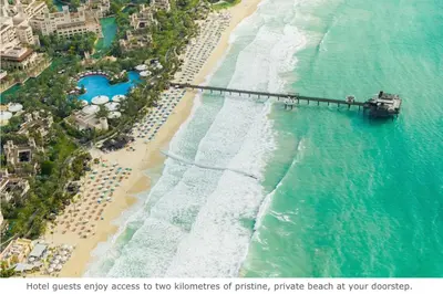 an aerial view of a beach with a pier at Jumeirah Al Qasr Dubai in Dubai