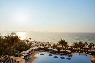 an aerial view of a resort with a pool and the ocean at Jumeirah Mina Al Salam Dubai in Dubai