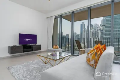 a living room with a couch and a tv at Dream Inn Apartments- Boulevard Heights in Dubai
