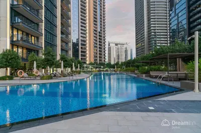 a large swimming pool in a city with tall buildings at Dream Inn Apartments- Boulevard Heights in Dubai