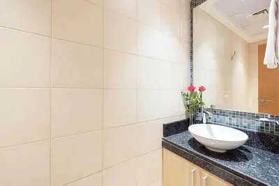 a bathroom with a white sink on a counter at Royal Club By RVHR, Palm Jumeirah in Dubai