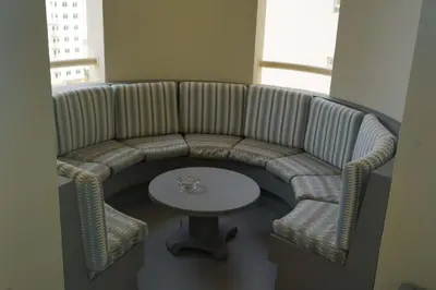 a couch with a table in a room at Royal Club By RVHR, Palm Jumeirah in Dubai