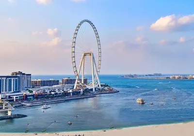a ferris wheel in the water next to a beach at Ramada Hotel, Suites and Apartments by Wyndham Dubai JBR in Dubai