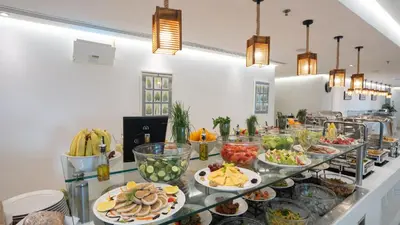 a buffet line with many plates of food at Ramada Hotel, Suites and Apartments by Wyndham Dubai JBR in Dubai