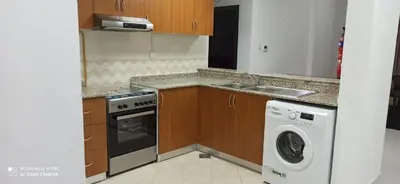 a kitchen with a washing machine and a sink at Furnished Studio Apartments for rent in Dubai in Dubai