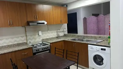 a kitchen with a sink and a washing machine at Furnished Studio Apartments for rent in Dubai in Dubai