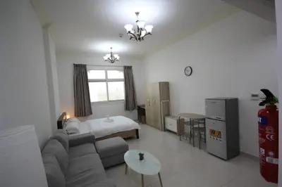a living room with a couch and a bed at Cozy Rooms and Small Partitions for Men guests in Dubai in Dubai