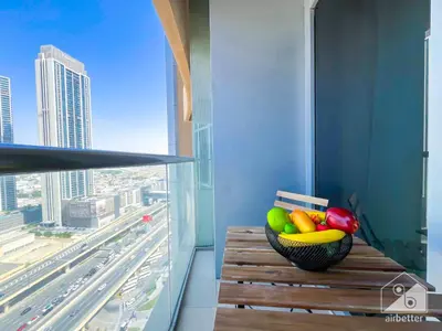 a bowl of fruit sitting on a wooden bench next to a window at Dubai Mall 1Bedroom Balcony in Dubai