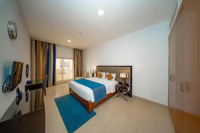 a large bedroom with a bed and a television at City Stay Grand Hotel Apartments - Al Barsha in Dubai