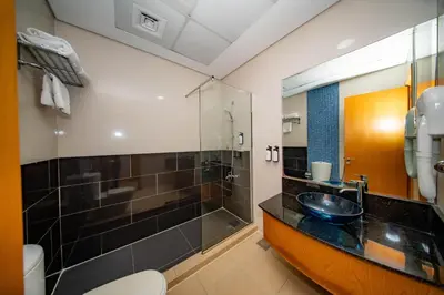 a bathroom with a sink and a shower at City Stay Grand Hotel Apartments - Al Barsha in Dubai
