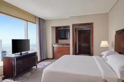 a hotel room with a bed and a television at Rose Rayhaan by Rotana - Dubai in Dubai