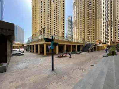 a building in the middle of a city with tall buildings at The Smart Concierge - Bahar 6 in Dubai