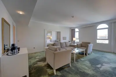 a living room with a couch and a table at Millennium Lakeview Hotel in Dubai