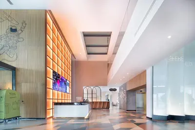 a lobby of a building with a reception desk at Ecos Dubai Hotel at Al Furjan in Dubai