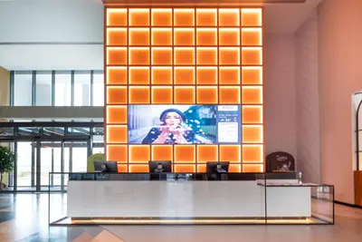 a lobby with a television on a wall at Ecos Dubai Hotel at Al Furjan in Dubai