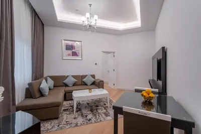 a living room with a couch and a tv at Rose Garden Hotel Apartments - Al Barsha, Near Metro Station in Dubai