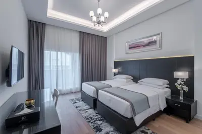 a bedroom with a large bed and a television at Rose Garden Hotel Apartments - Al Barsha, Near Metro Station in Dubai