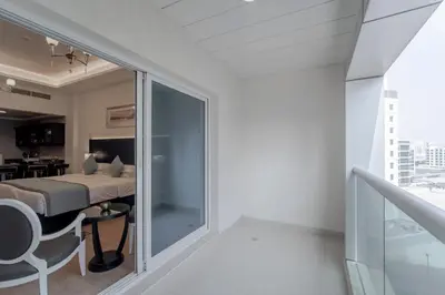 a room with a bed and a glass door at Rose Garden Hotel Apartments - Al Barsha, Near Metro Station in Dubai