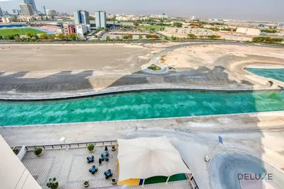 an aerial view of a beach and the ocean at Sunny 1BR at Canal Residences West Dubai Sports City by Deluxe Holiday Homes in Dubai