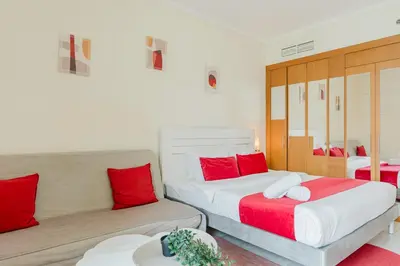 a bedroom with two beds and a couch at RH - Beautiful canal view, Sleek & spacious Studio, central location in Dubai