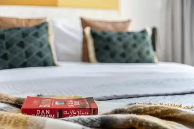 a bedroom with two beds and a book on the bed at The Smart Concierge - Bay Central in Dubai