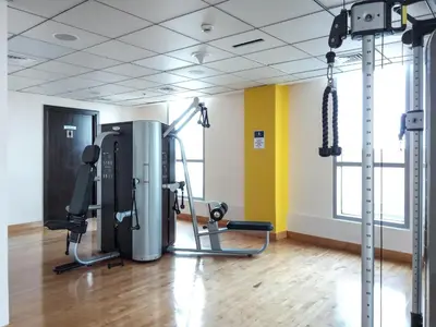 a room with a gym with exercise equipment in it at The Smart Concierge - Bay Central in Dubai